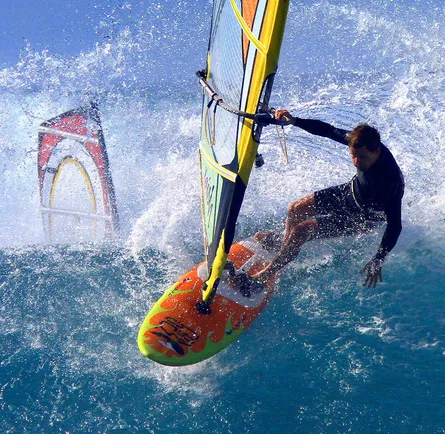 Surfer rides wave on surfboard
