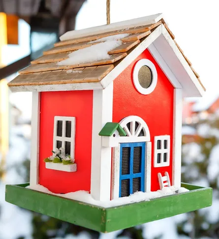 Red toy house hanging from ceiling