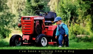 Boy standing by tractor
