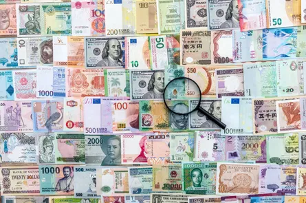 Magnifying glass on pile of money
