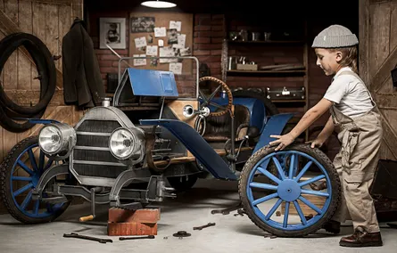 Little Boy in Front of Old Car
