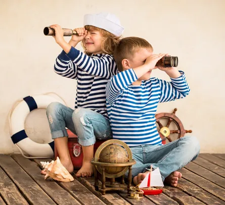 Two children looking through telescope