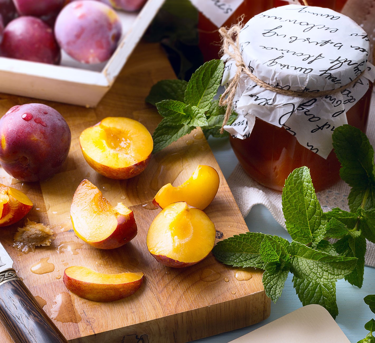 Stone fruits sliced on cutting board