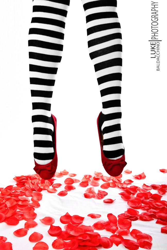 Red Shoes with Black and White Striped Socks on Model